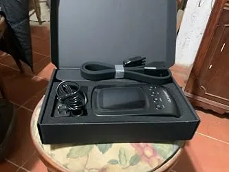 Uploaded photo of packaging and accessories for a leg compression massage device
